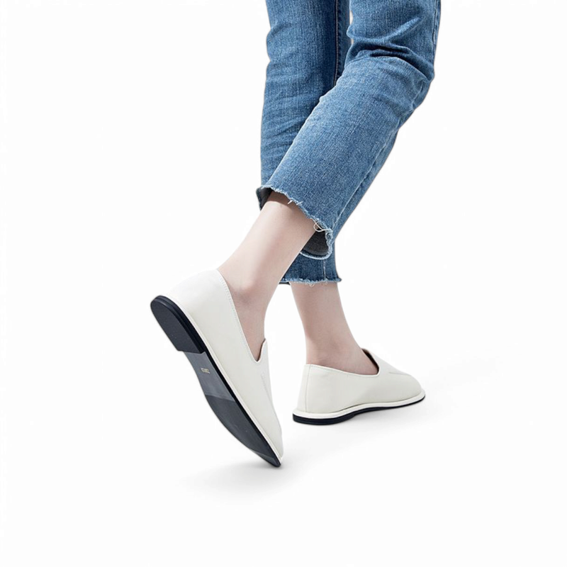 Shot of the black‑and‑white outsole of a white loafer in motion