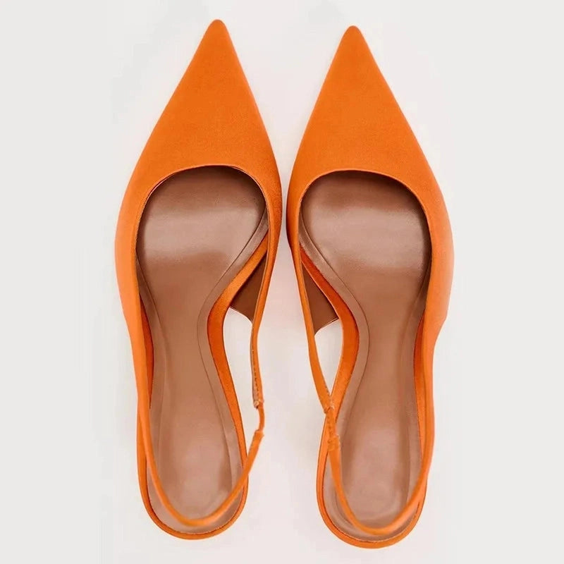 Overhead view highlighting pointed toes and slim straps