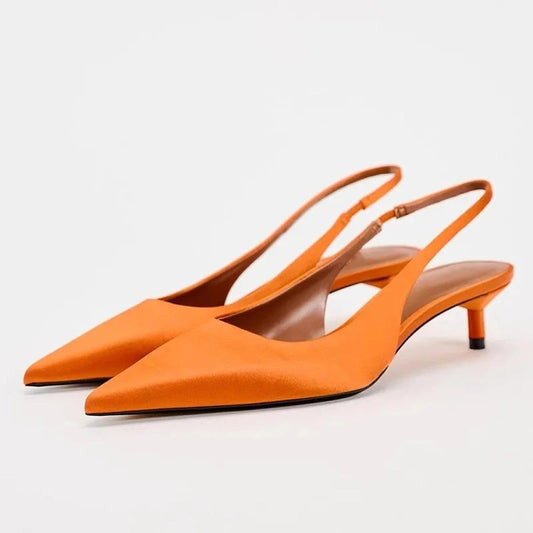Side perspective showing the sleek profile and low kitten heel
