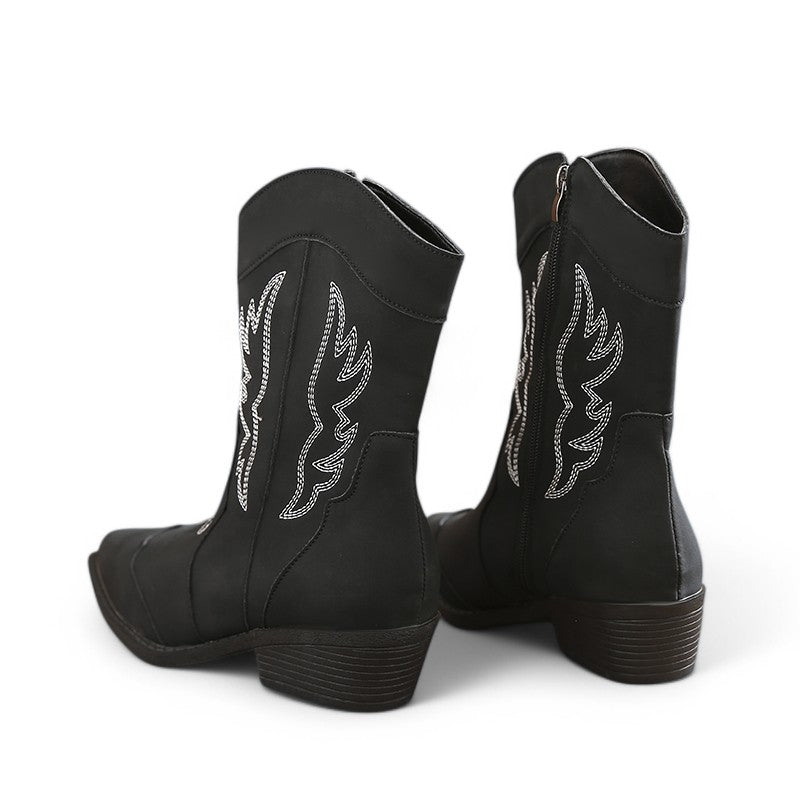 Rear view of black Merendy Randa boots showing white side embroidery and low square heels.
