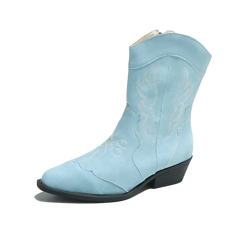 Side view of a single light blue Merendy Randa boot with pointed toe and contrast stitching.

