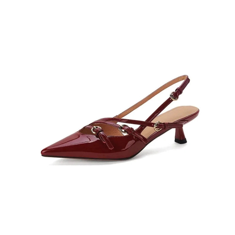 Single burgundy patent pump, side profile emphasising straps and heel.