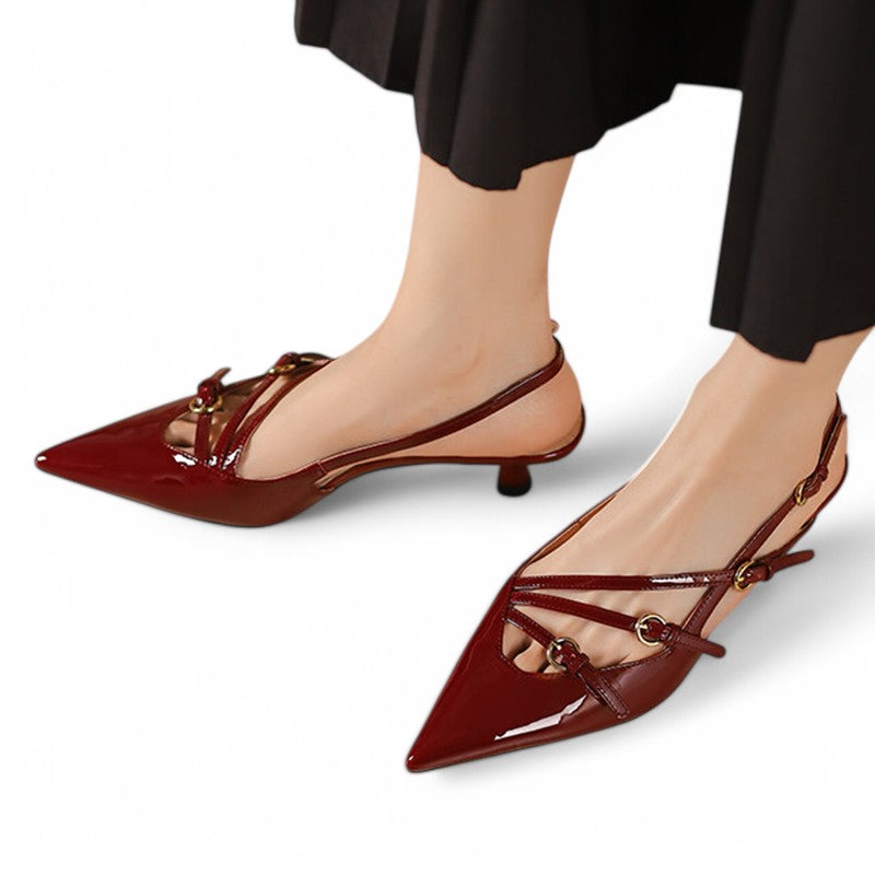 Burgundy patent slingback pump on foot, low kitten heel and buckle straps.