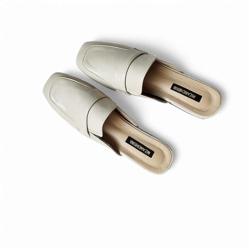 Beige square‑toe mule pair top view on white background