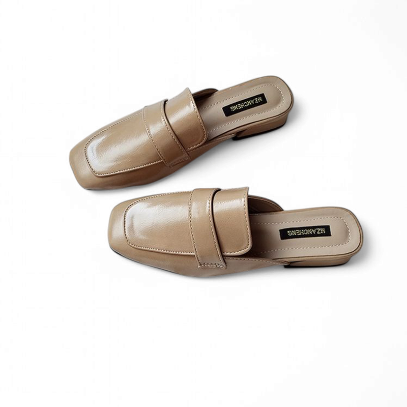 Pair of glossy caramel square‑toe mules with low heel shown angled from above