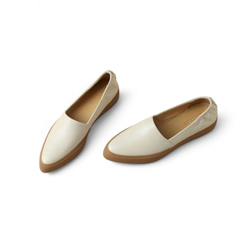 Pair of cream‑beige slip‑on loafers with brown cup sole, top angle