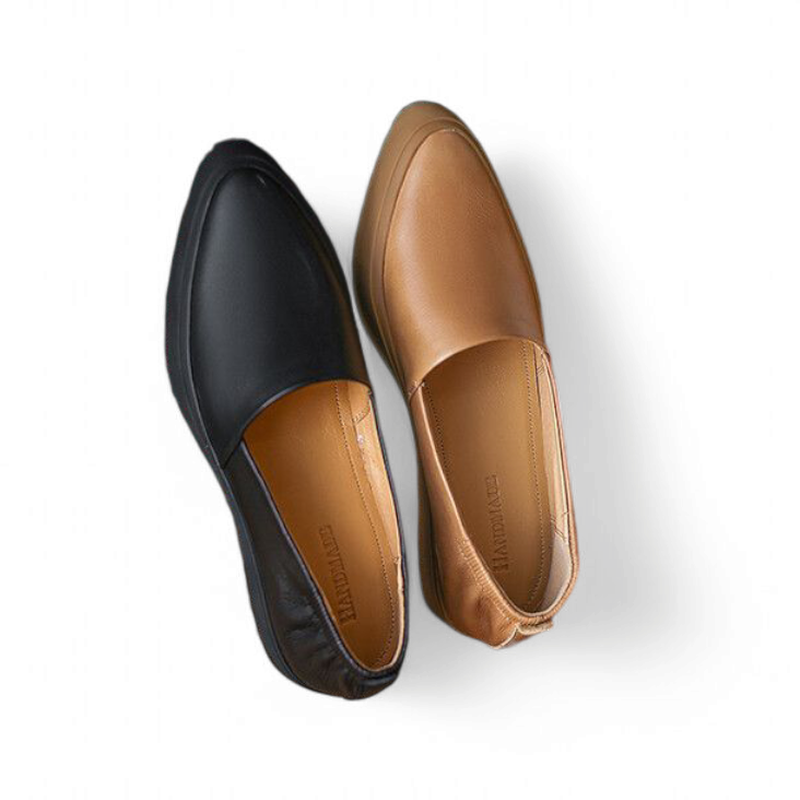Black and camel loafers placed side by side, top view