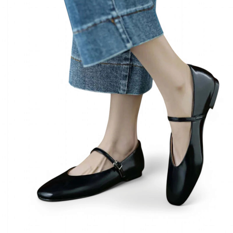 Side view of a low‑heel black Mary‑Jane worn with wide‑leg jeans