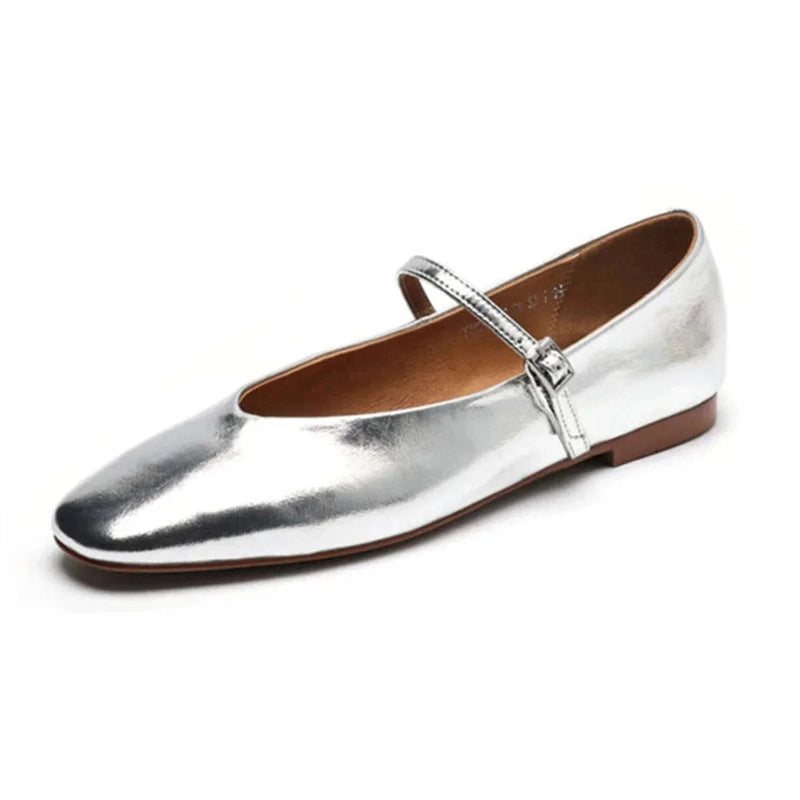 Shiny silver low‑heel Mary‑Jane with buckle strap on white background