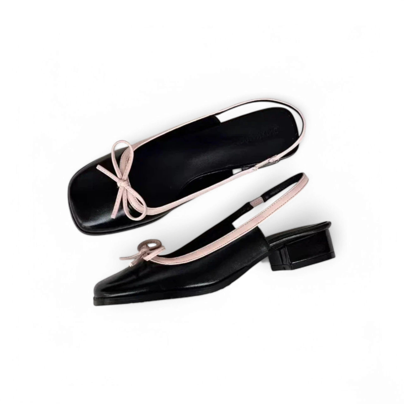 Side and partial top view of black slingback ballet flats with pink piping and a low block heel