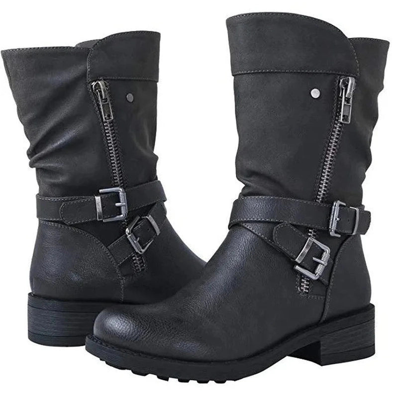 Both Merendy Santos boots shown together in a clean frame, highlighting the wide-calf cut, rounded toes, and sleek black finish.