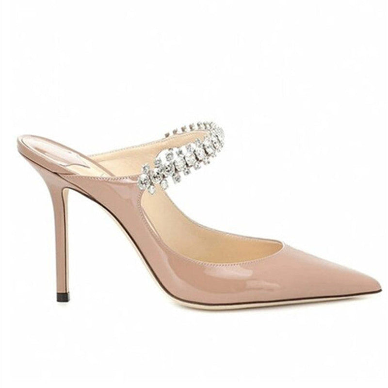Nude patent mule, pointed toe, crystal‑set strap, isolated on white