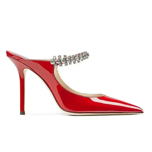 Red patent mule, pointed toe, crystal‑set strap, slim stiletto heel profile