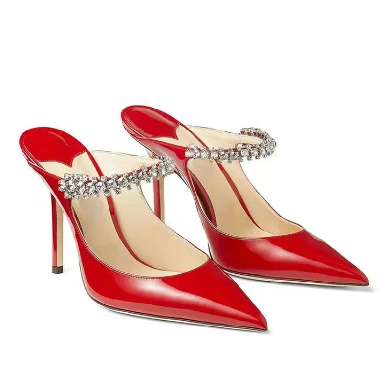 Pair of red patent mules, crystal strap across instep, angled view