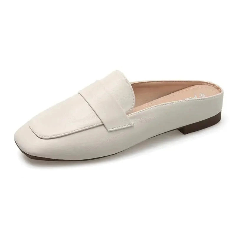 Side profile of the ivory Merendy Snow square-toe mule showing low flat heel.