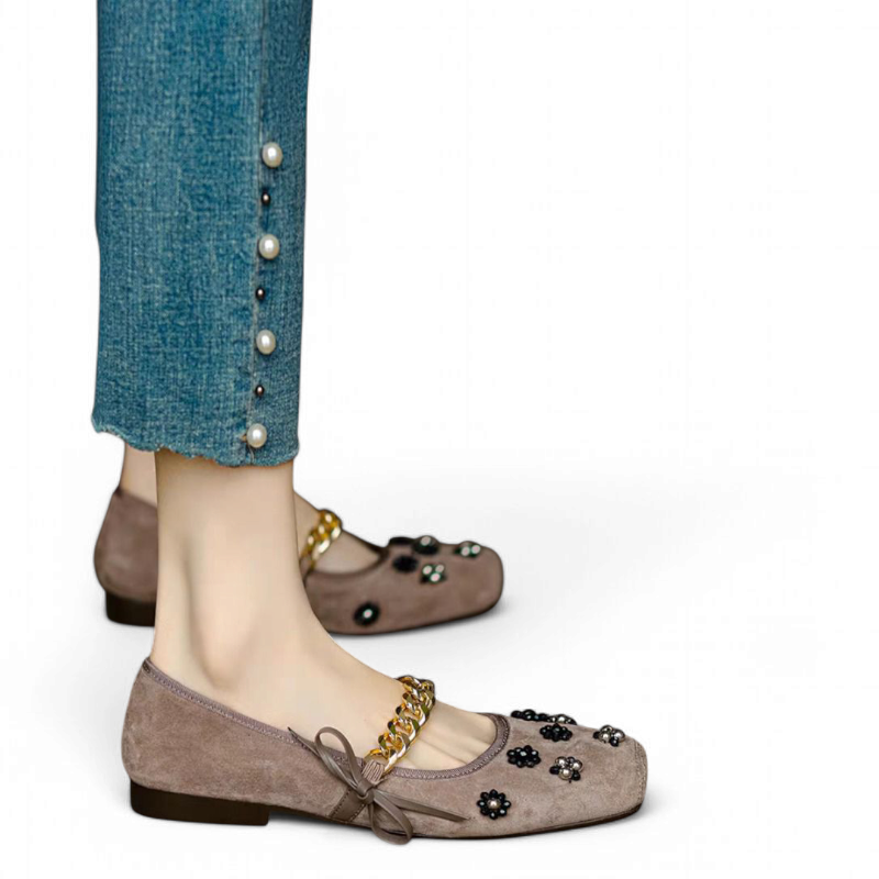 Taupe ballerina flat with gold chain strap and black bead flowers on a square toe.