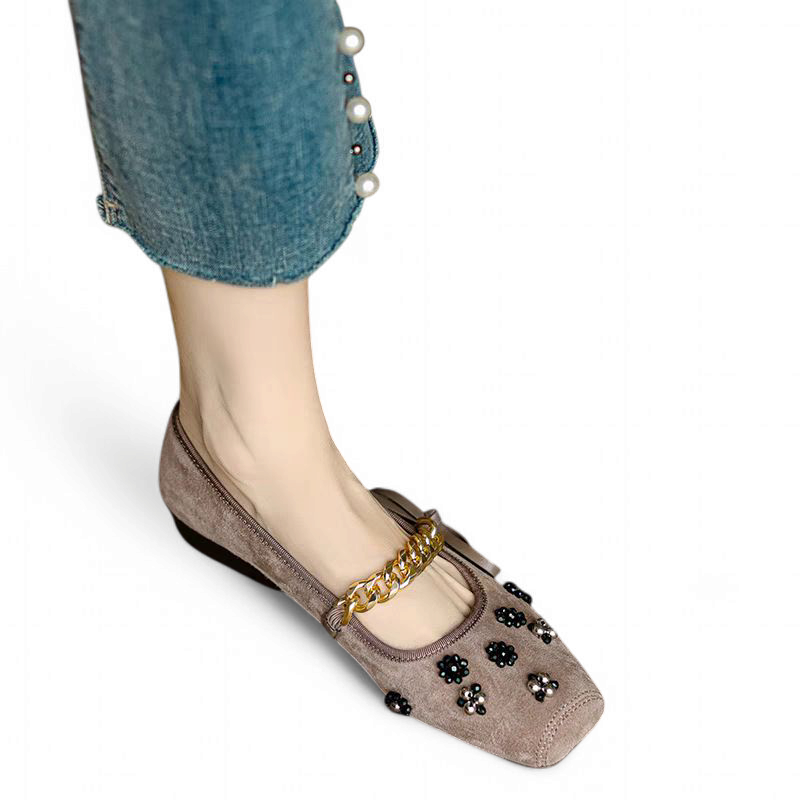 Top-down view of taupe flat highlighting gold chain and square toe.