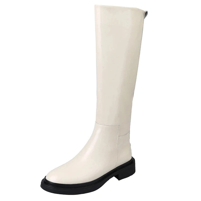 Front view of a single Merendy Sustate white knee-high boot, emphasizing its crisp finish and round toe structure.