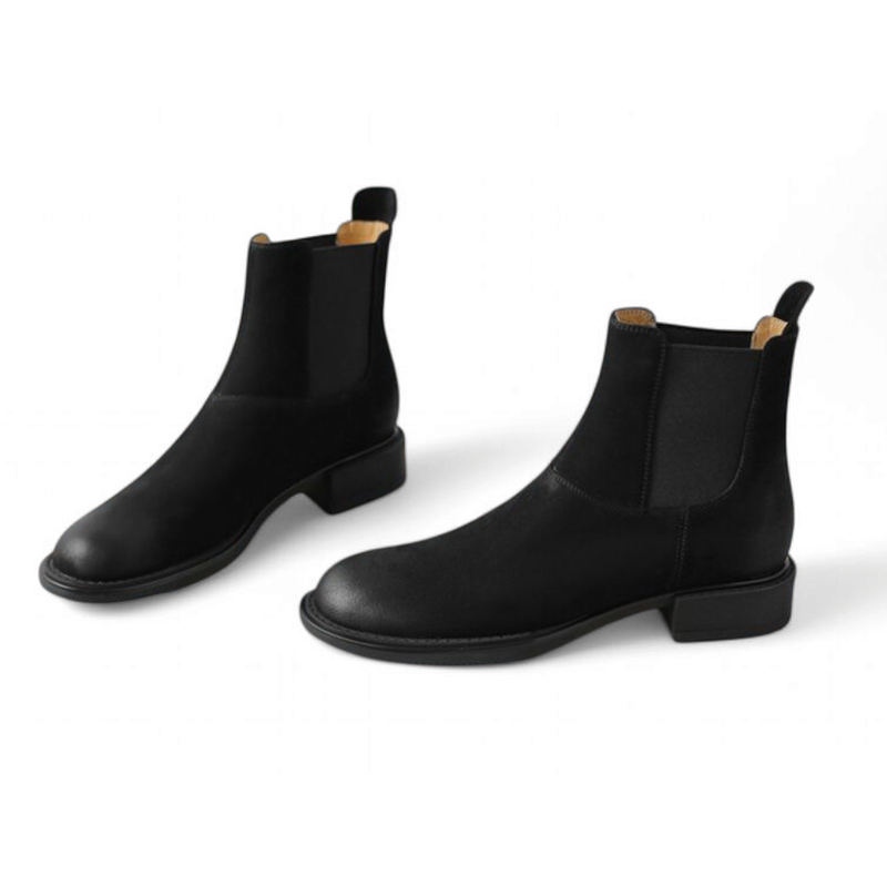 Black Chelsea boots with round toe, front angled view of both boots