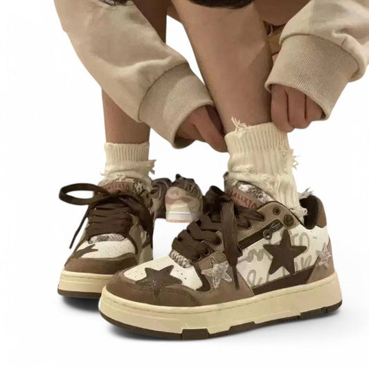 Dark khaki and off-white sneaker with contrasting stars; bending shot shows chunky sole.