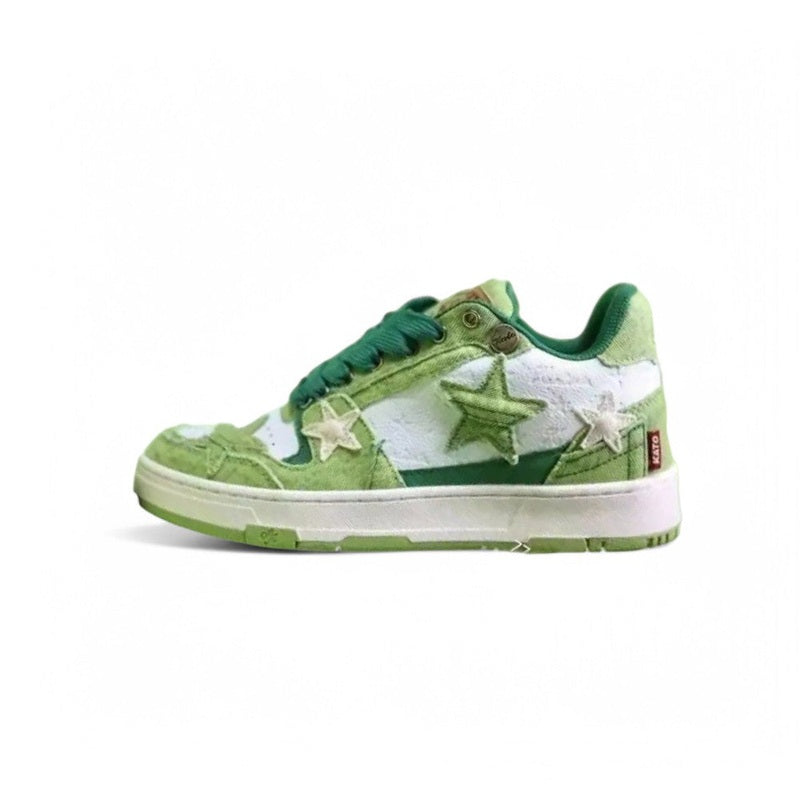 Low-top light-green sneaker with suede stars and cream rubber sole.

