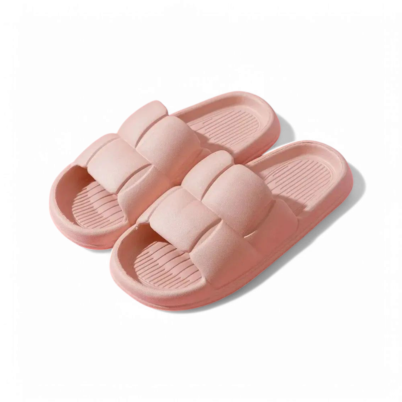 Open-toe home slide with a wide pillow strap in blush pink on a cushioned footbed.