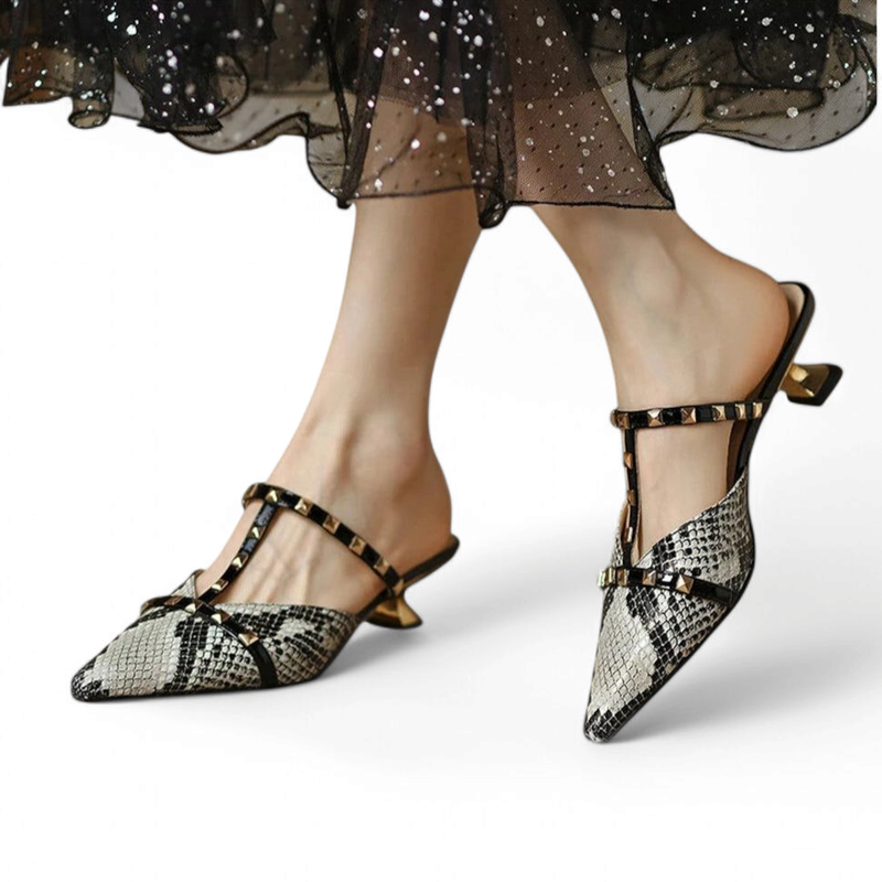 Beige python-print mule with polished gold kitten heel and stud-trim T-strap, white background