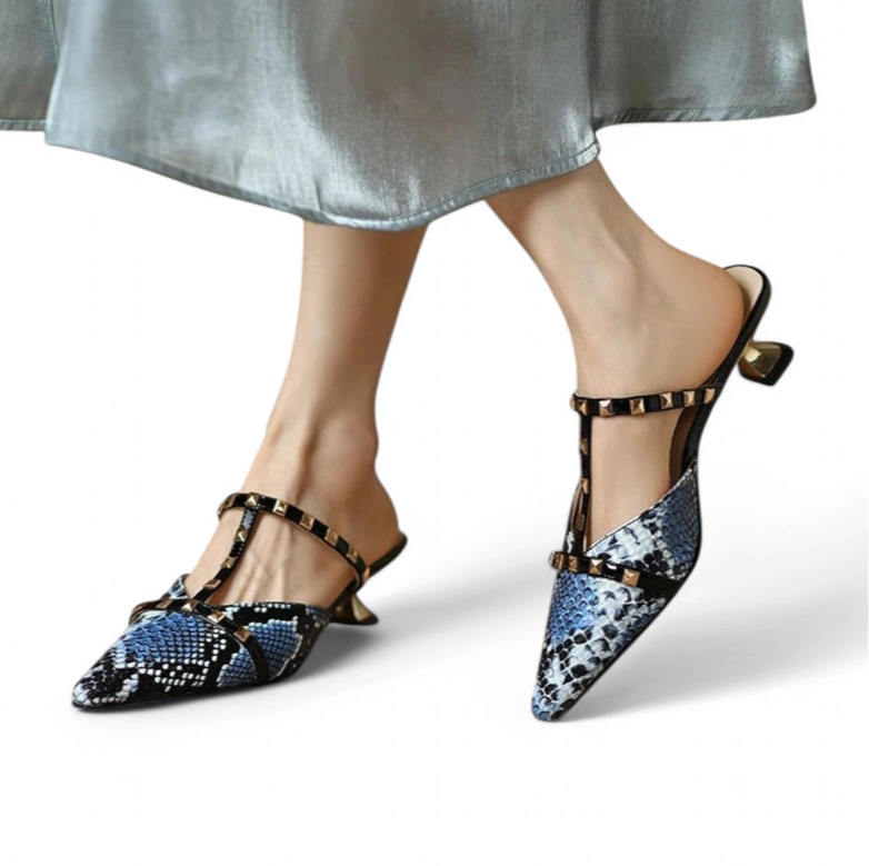 Open-back mule with blue python print, kitten heel and gold-stud T-strap, worn by model, white background