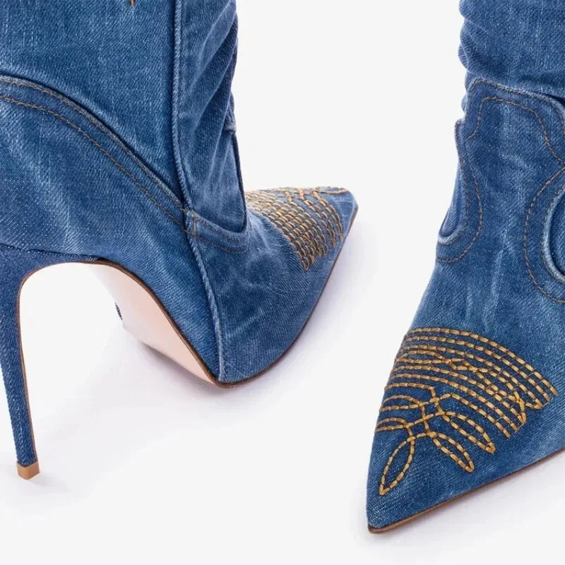 Close-up shot showing the stitching precision and golden embroidery at the heel and pointed toe