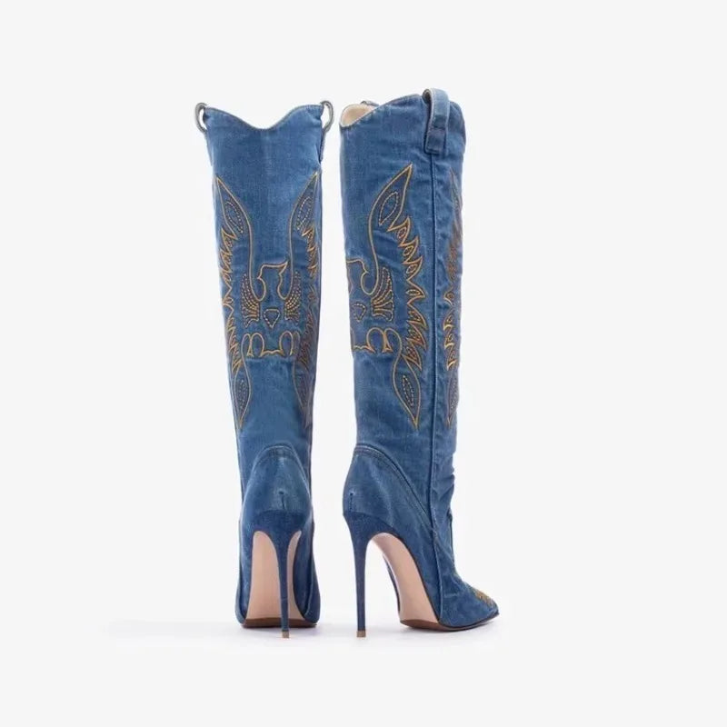 Rear view of tall denim boots, showing symmetrical embroidery and slim high heels