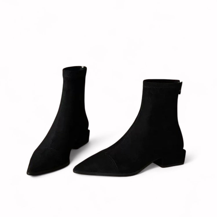 modern black women’s ankle boots made of soft faux suede with a pointed toe, above-ankle height, and rear zip closure.
