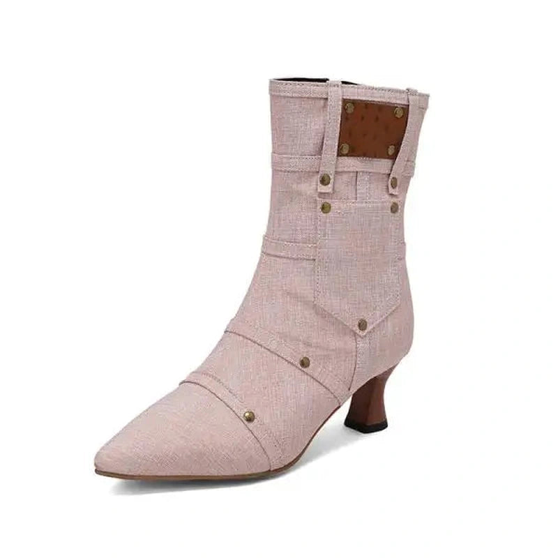 Blush-pink denim ankle boot with pocket-style stitching and brown heel.