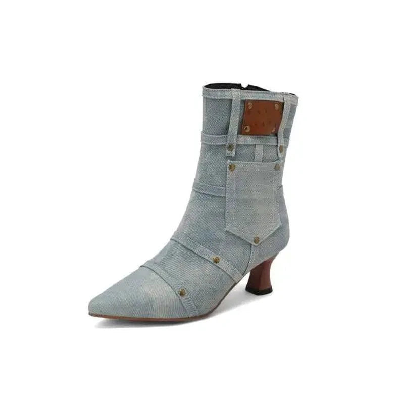 light-blue denim ankle boot displaying side pocket panel and studs.