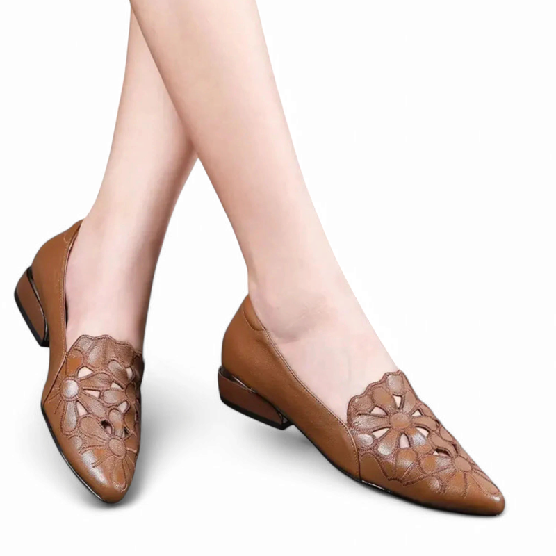 Brown low-heel flats shown on feet, front-side angle.
