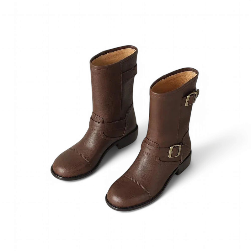 Matching pair of brown leather boots, styled with symmetry and quiet sophistication.