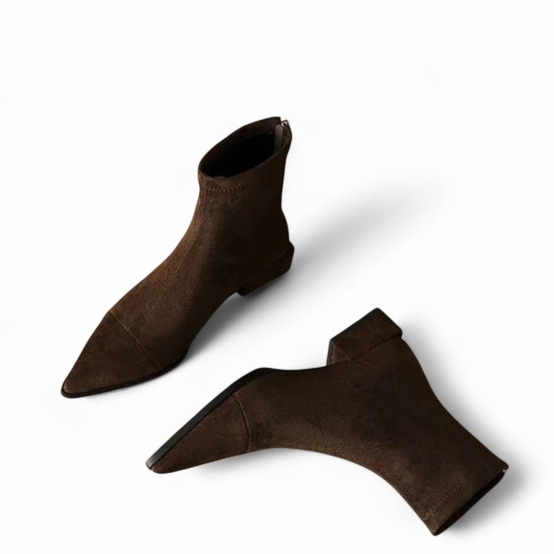  a pair of brown  faux suede women’s ankle boots with soft texture, pointed toe, low square heel, and minimalist above-ankle silhouette.