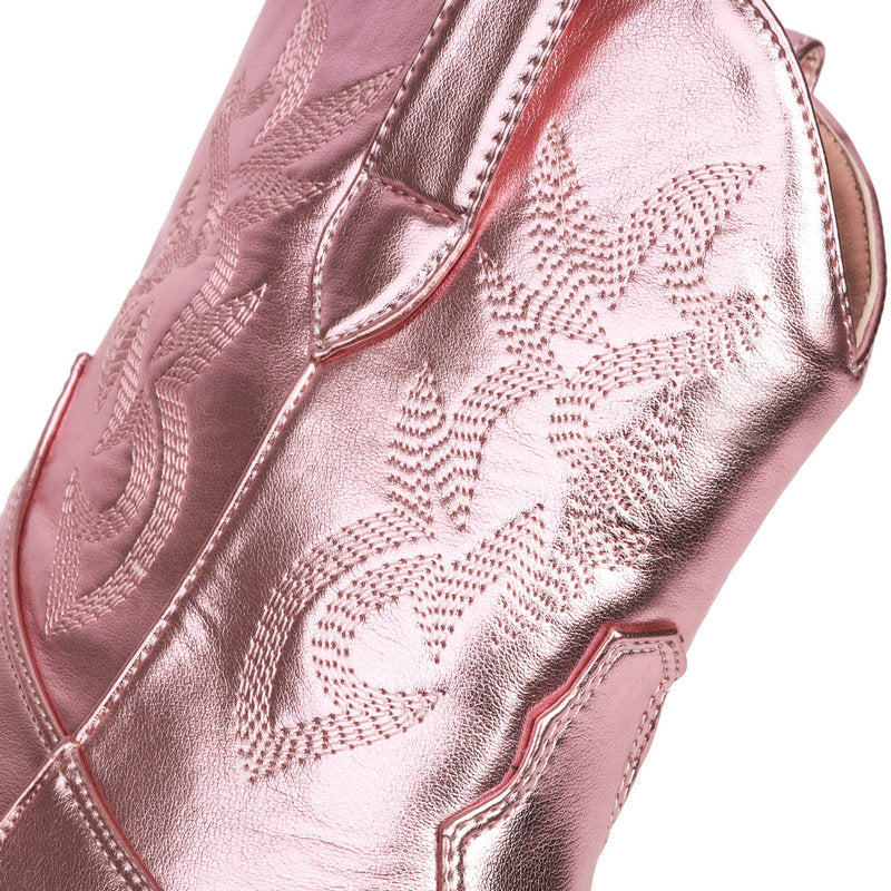 Close-up of western embroidery on pink metallic leather.
