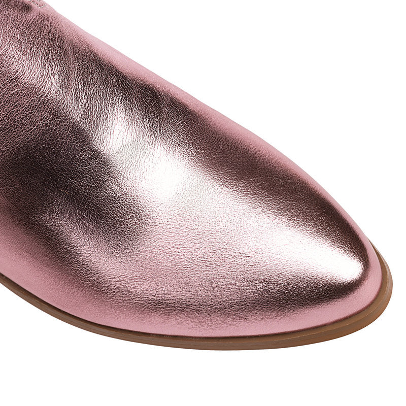 Close-up of pointed toe in glossy pink metallic finish.