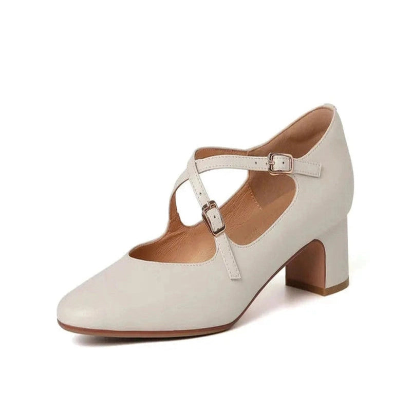 Ivory leather Mary-Jane with mid block heel and twin cross-straps, side studio view on white background.