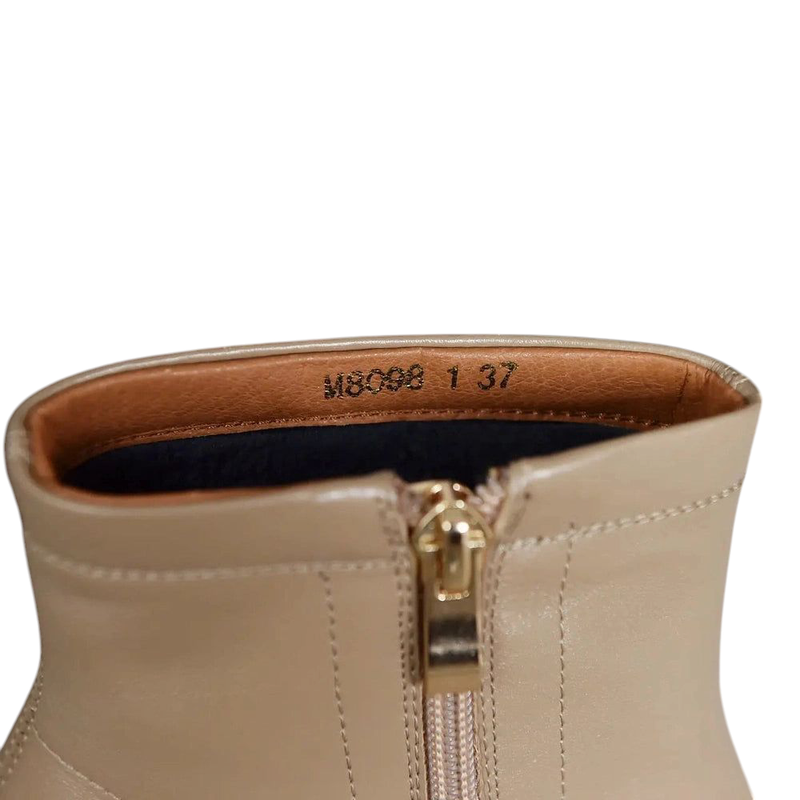 Close-up of golden zipper detail on top of Ranya leather boots