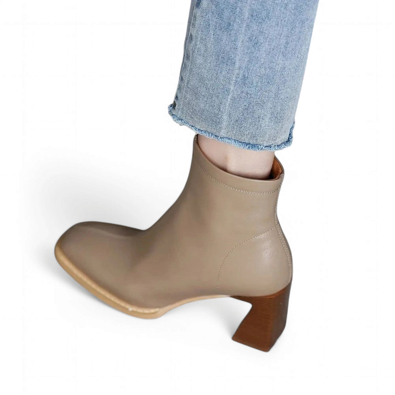 Ranya leather boots with angled heel and square toe, shown worn from side