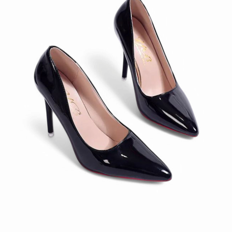Angled view of glossy black pointed-toe stilettos with slim high heels.
