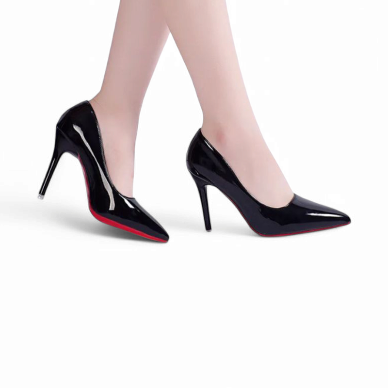 Side on-foot view of glossy black stilettos while model walks.