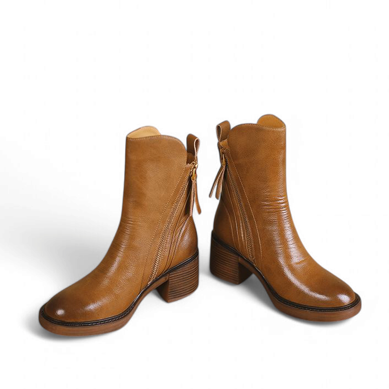 Brown leather boots pair displayed front angle on white background

