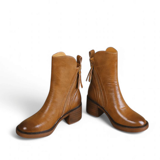 Brown leather boots pair displayed front angle on white background

