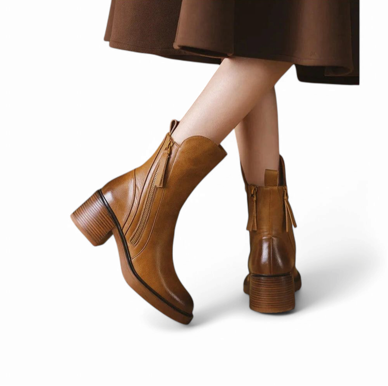 Brown leather boots with mid-height heel seen from the back on feet

