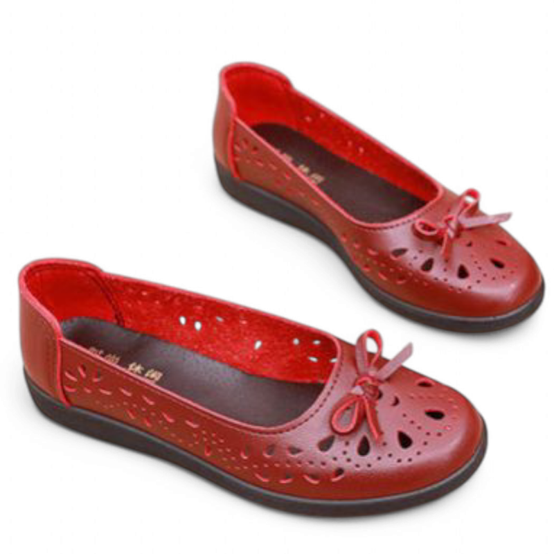 Angled top view of red pair highlighting ventilation holes and low black sole.