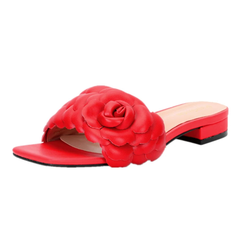 Perspective view of vivid red slide with leather rose across vamp and flat block heel.