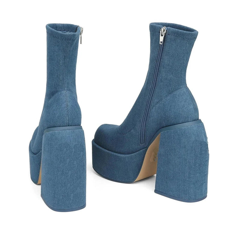 Back angle highlighting metal side zipper and thick platform sole.