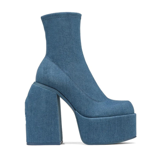 Side view showing sleek shaft, square toe and seamless denim cover.